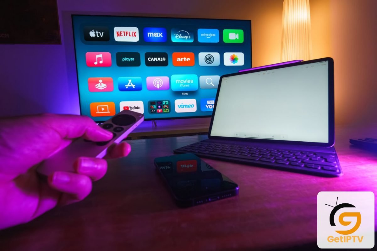 Real photo of a home entertainment setup with TV tablet and smartphone; GetIPTV logo added
