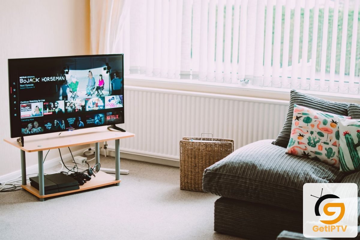Real photo of a smart TV in a comfortable living room displaying streaming media; GetIPTV logo added